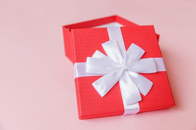 Simply minimal design red gift box isolated on pink background