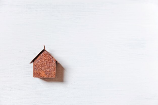 Simply minimal design with miniature toy house isolated on white background