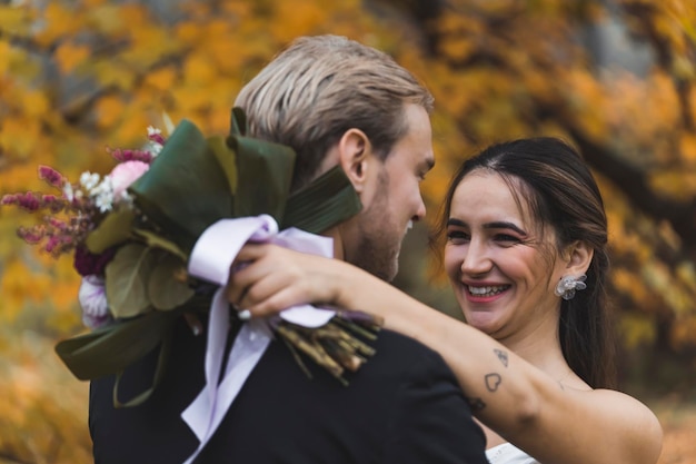 Sincere happiness of newlyweds closeup portrait of middleeastern bride holding fresh bouquet hugging