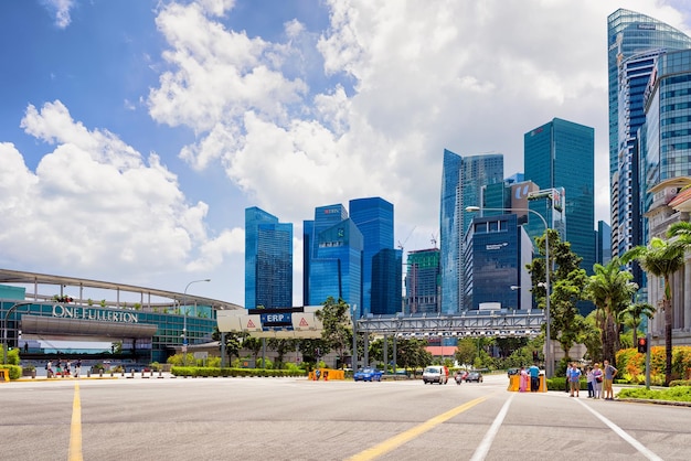 Singapore, Singapore - March 1, 2016: Skyscrapers at Fullerton Road in Singapore. Tall buildings on the background. Tourists in the street