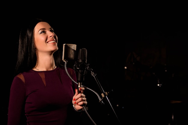 Singer recording a song in music studio.