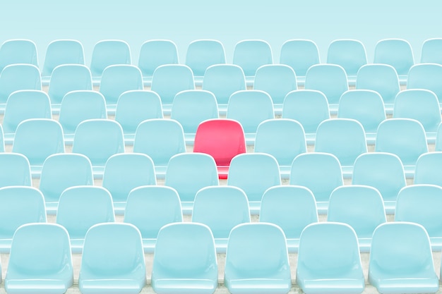 SInger red seat in the middle of light blue chair in stadium .