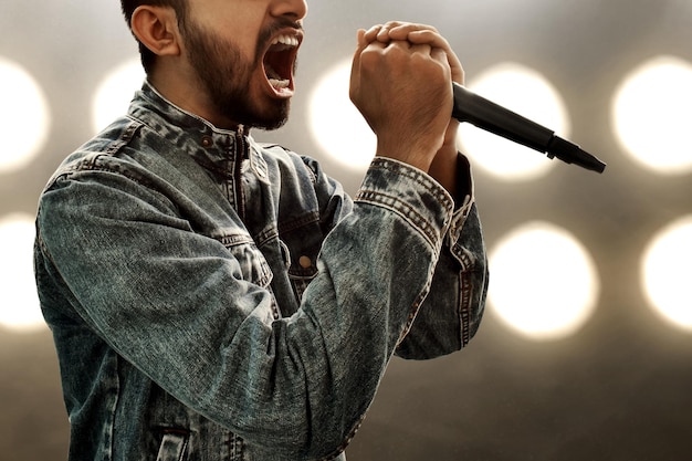 Foto cantante che canta con il microfono