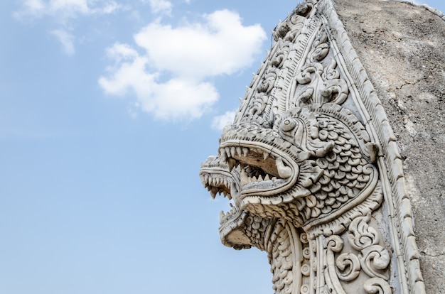 Singha and naga statue at Wat Prathat Lampang Luang Temple, Lampang, Thailand