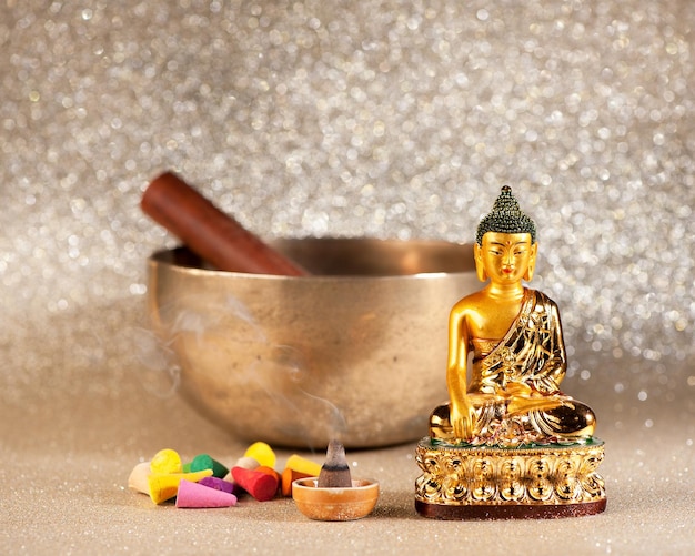 Singing Bowl incense sticks and Buddha statue meditation concept