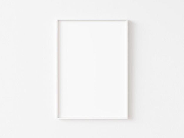 Single blank vertically oriented rectangular picture frame with white border hanging on white wall