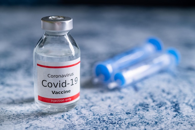 A single bottle vial of Covid19 vaccine Medical concept vaccination hypodermic injection treatment Vaccine and syringe injection