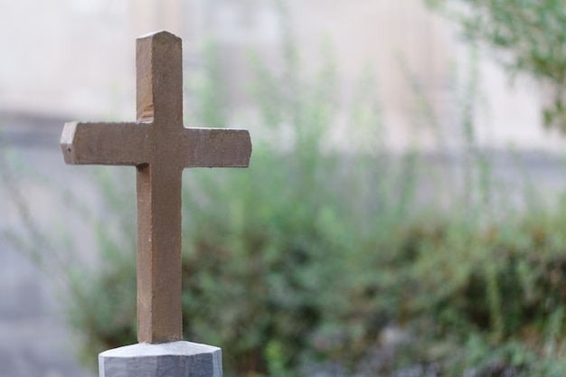 Single cross headstone in graveyard