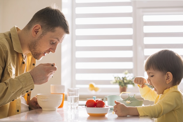 Photo single-father and child eating cereals