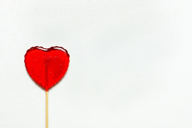 Single heart-shaped lollipop of valentines day isolated on white background