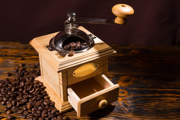 Single manual coffee grinder with scattered beans