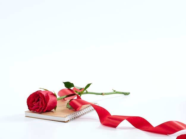 Single red rose on a diary.