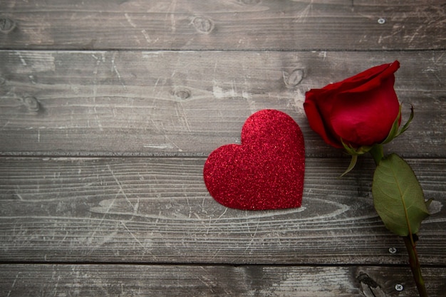 single red rose on a wooden background romantic background