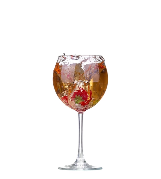 Single Strawberry splashing into a glass of wine