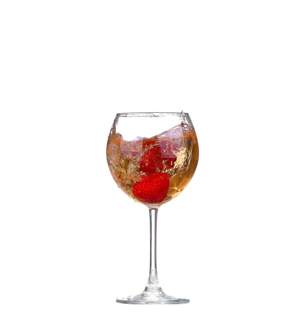 Single Strawberry splashing into a glass of wine