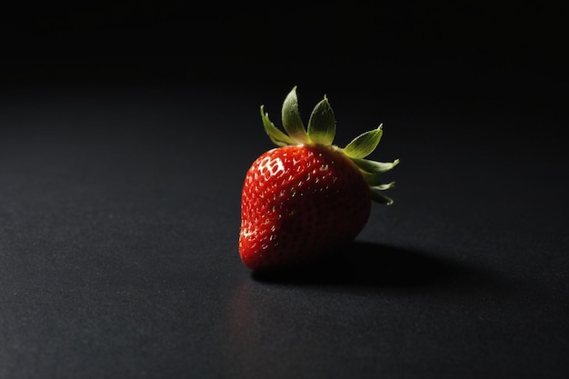 A single strawberry on the table