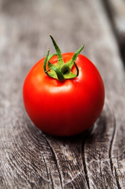 Single Tomato on wooden table