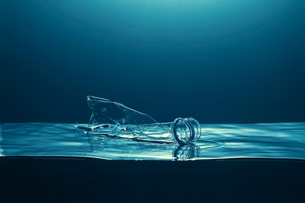 Single use plastic bottle floating in the ocean