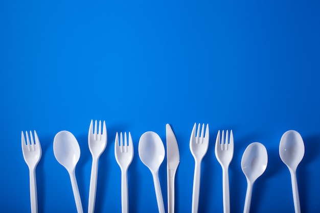 Single use plastic forks, spoons. concept of recycling plastic, plastic waste