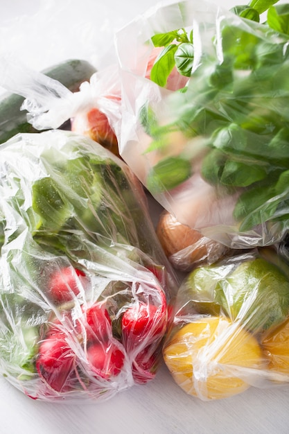 Single use plastic waste issue. fruits and vegetables in plastic bags