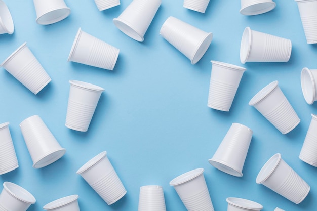 Single use white plastic cups on a blue background