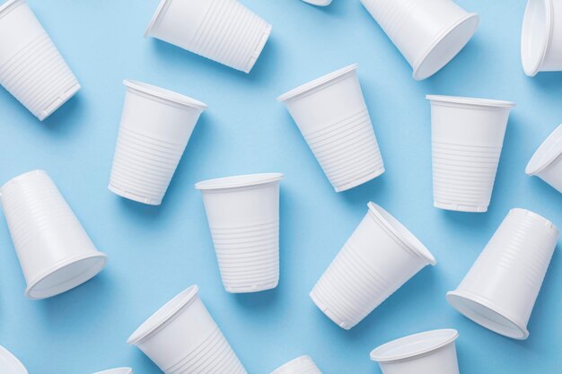 Single use white plastic cups on a blue background