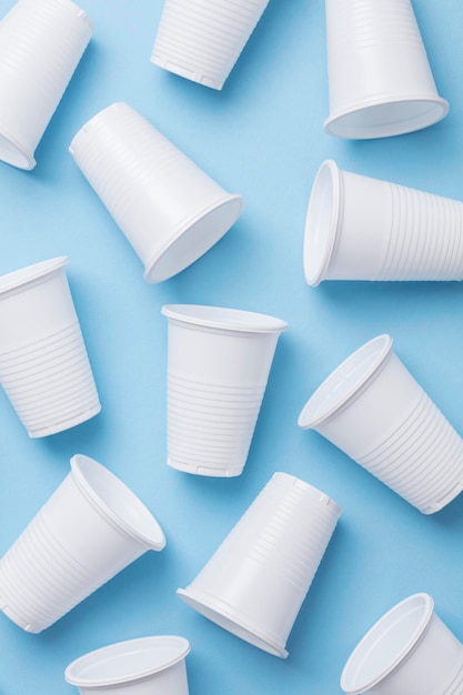 Single use white plastic cups on a blue background