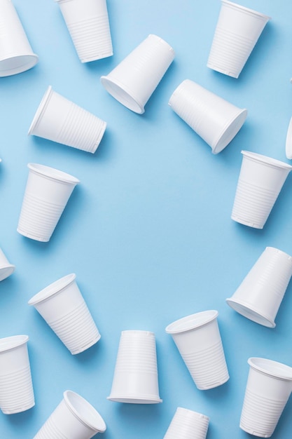 Single use white plastic cups on a blue background