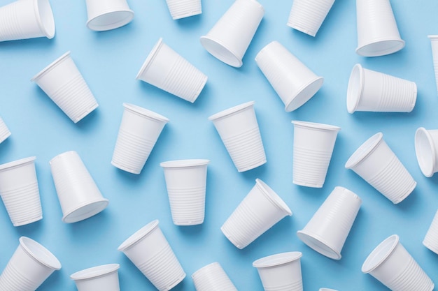 Single use white plastic cups on a blue background