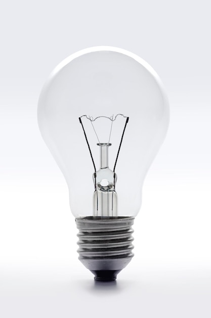 Single vintage clear lightbulb on white background