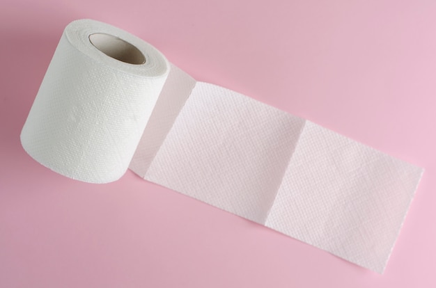 Single white toilet paper roll on pastel pink