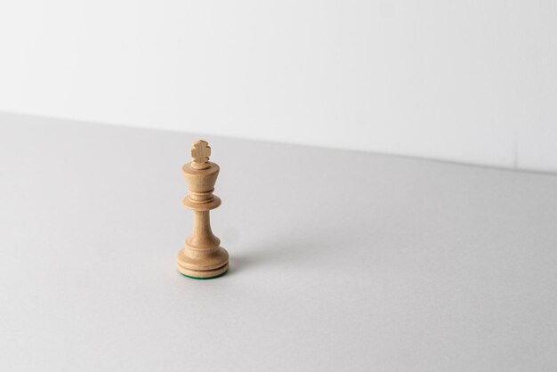 A single wooden chess king piece leadership concept