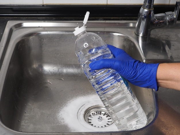 Sink drain cleaning process using baking soda and white vinegar