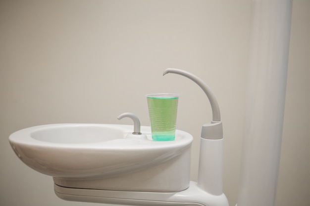 Sink with a glass of water in the dental office