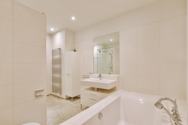 Sinks and bathtub near shower cabin