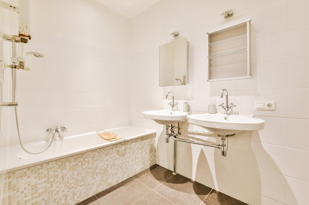 Sinks and bathtub near shower cabin