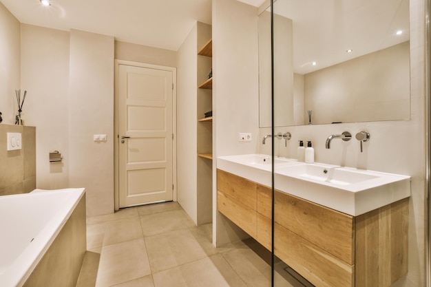 Sinks and bathtub near shower cabin