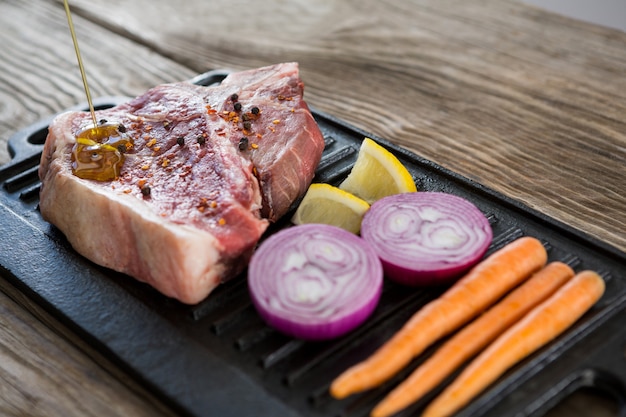 Sirloin chop and ingredients on grill tray