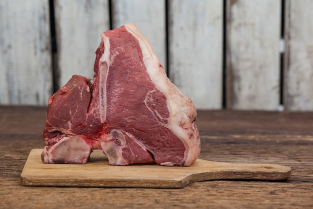 Sirloin chop on wooden board