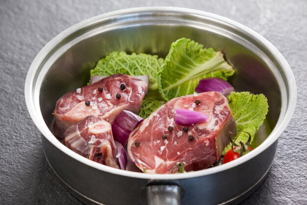 Sirloin chops and ingredients in frying pan