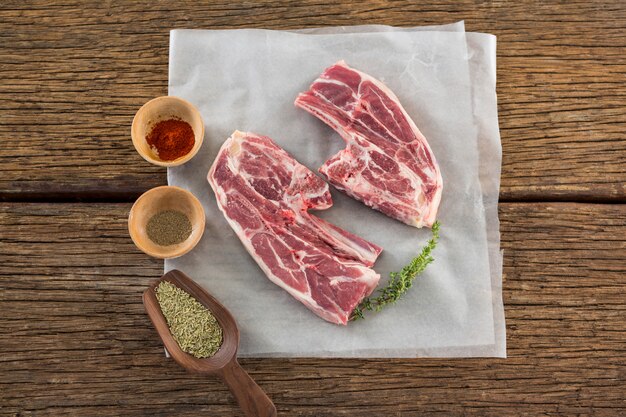 Sirloin steak and ingredients against wooden table