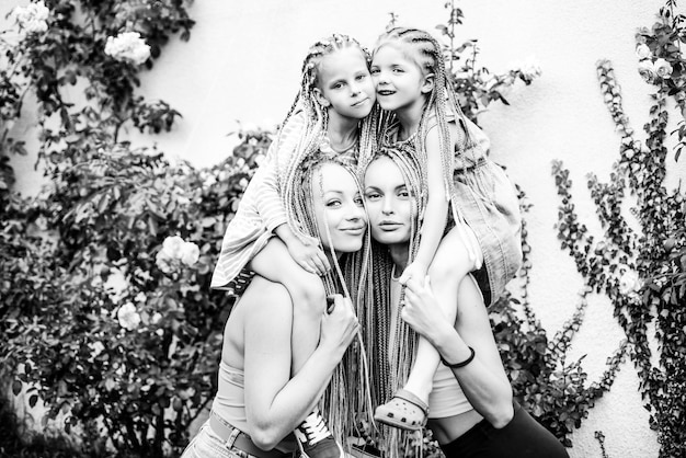 Sister family having fun outdoor cute positive best friend pretty young girls spring time hugs