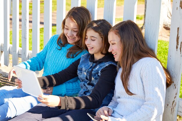 Sister girls friends having fun with technology