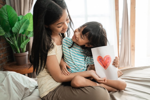 Sister giving surprise love card