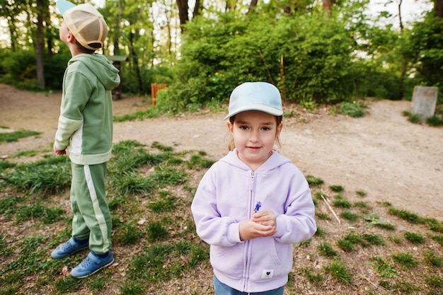 Sister with brother walking in forest