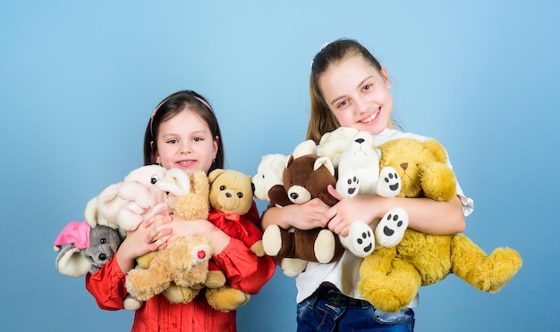 Sisters best friends play sweet childhood childhood concept softness and tenderness laundry softener love and friendship kids adorable cute girls play soft toys happy childhood child care