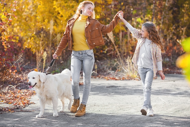 Sisters and dog in park