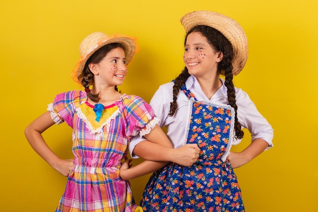 Sisters and friends wearing typical clothes of the Festa Junina Dancing partying playing