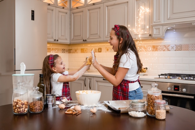 sisters at home cooking together