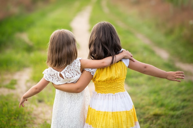 sisters hugging the road the concept of freedom happiness and childhood summer